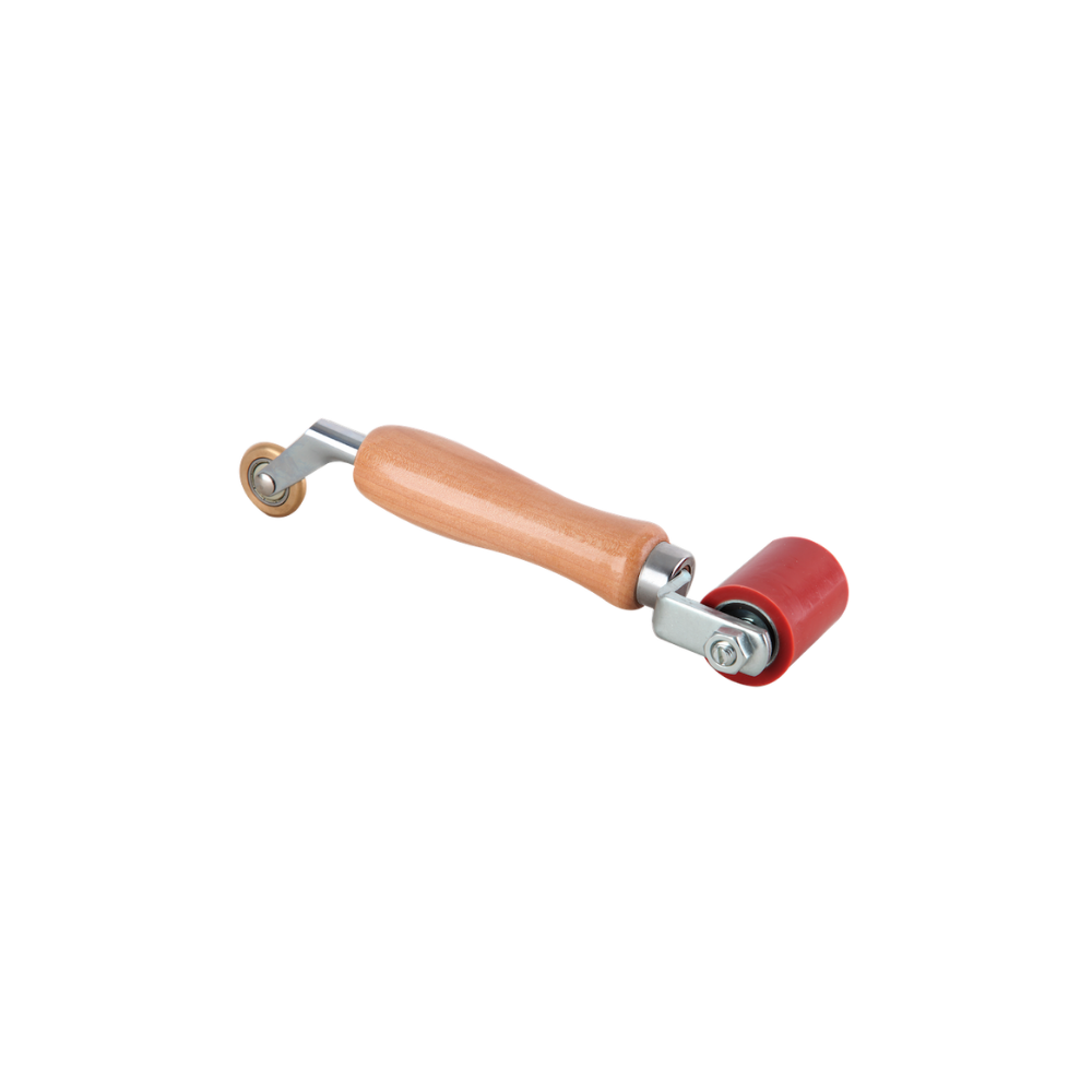 A wooden-handled roller which has one flattened, red, silicone end for smoothing, and one small vertical brown wheel for finer detail in corners. 